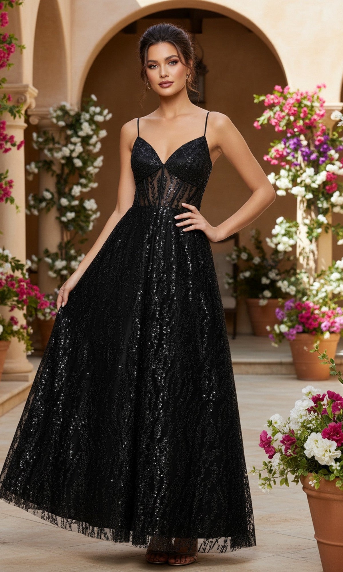 A woman in the Blondie Nites 5265BN long prom dress—sleeveless, floor-length, black sequined with a corset-style bodice—stands in a courtyard featuring potted flowers and archways.